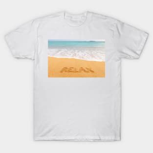 Inscription "RELAX" made on beautiful beach by the blue sea T-Shirt